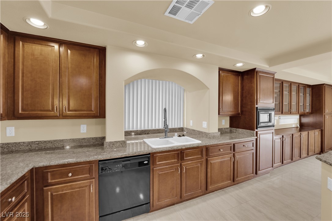 1142 Sax Fifth Avenue Henderson, NV 89052 - Photo 20 of 44 Bright and clean sink area with arched niche, tall cabinets, and extended counter space.