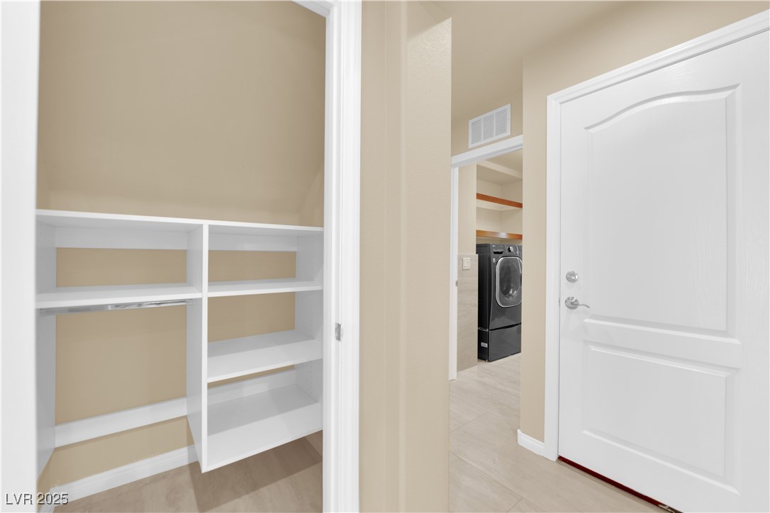 1142 Sax Fifth Avenue Henderson, NV 89052 - Photo 22 of 44 Spacious hallway storage closet with built-in shelving—perfect for pantry or linens.