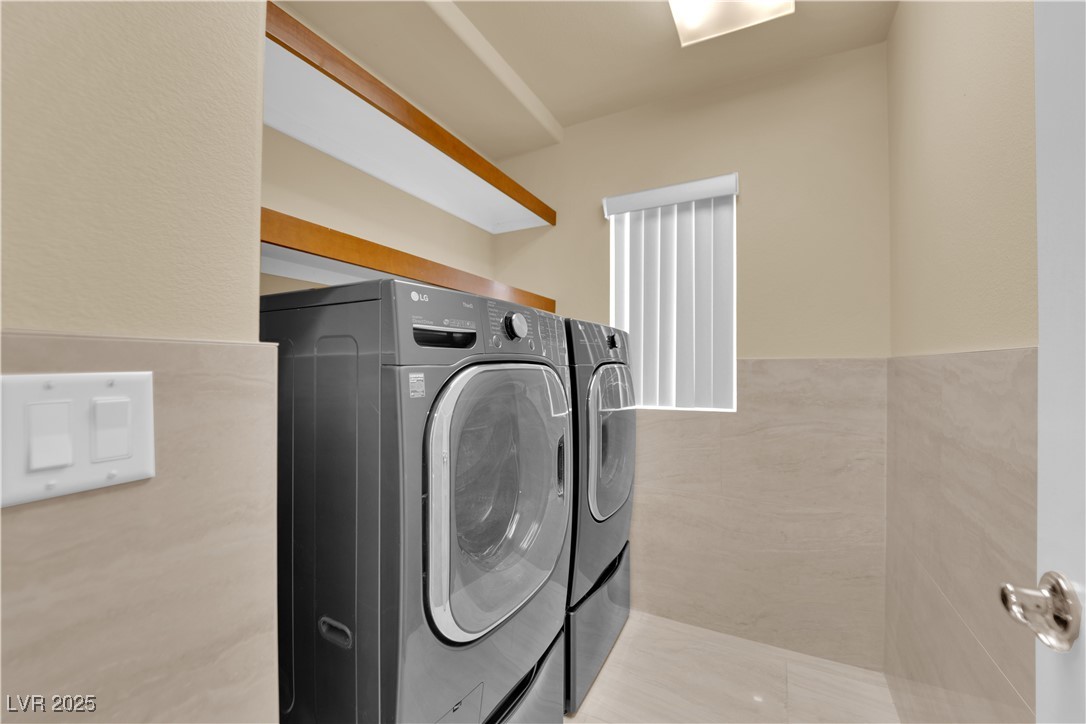 1142 Sax Fifth Avenue Henderson, NV 89052 - Photo 24 of 44 Convenient laundry room with full-size washer & dryer and upper shelving for storage.