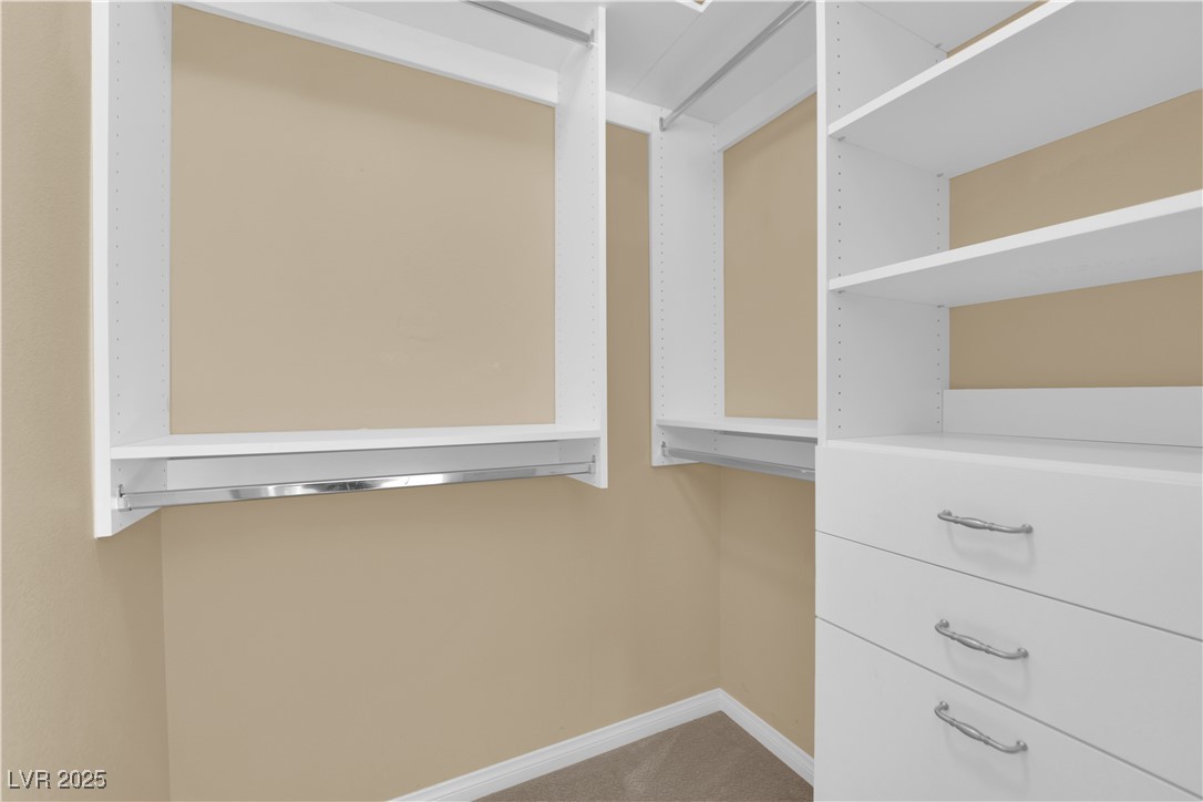 1142 Sax Fifth Avenue Henderson, NV 89052 - Photo 28 of 44 Custom built-in walk-in closet with shelving, drawers, and hanging space.