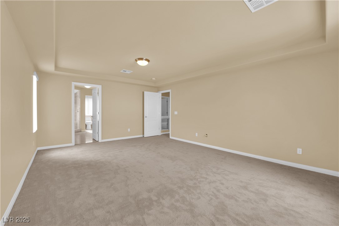 1142 Sax Fifth Avenue Henderson, NV 89052 - Photo 34 of 44 Spacious owner’s suite with direct access to the upgraded bathroom and walk-in closet.