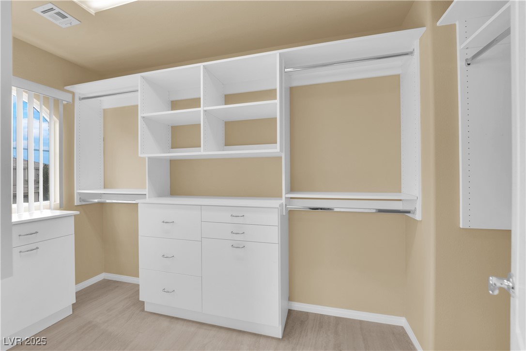 1142 Sax Fifth Avenue Henderson, NV 89052 - Photo 38 of 44 Custom-built walk-in closet with drawers, shelving, and ample hanging space.