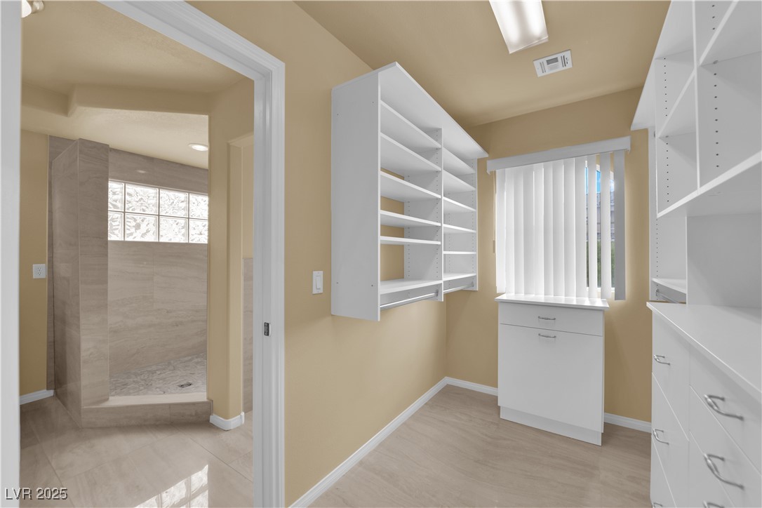 1142 Sax Fifth Avenue Henderson, NV 89052 - Photo 39 of 44 Walk-in closet with abundant storage and direct access to the spacious primary bathroom.