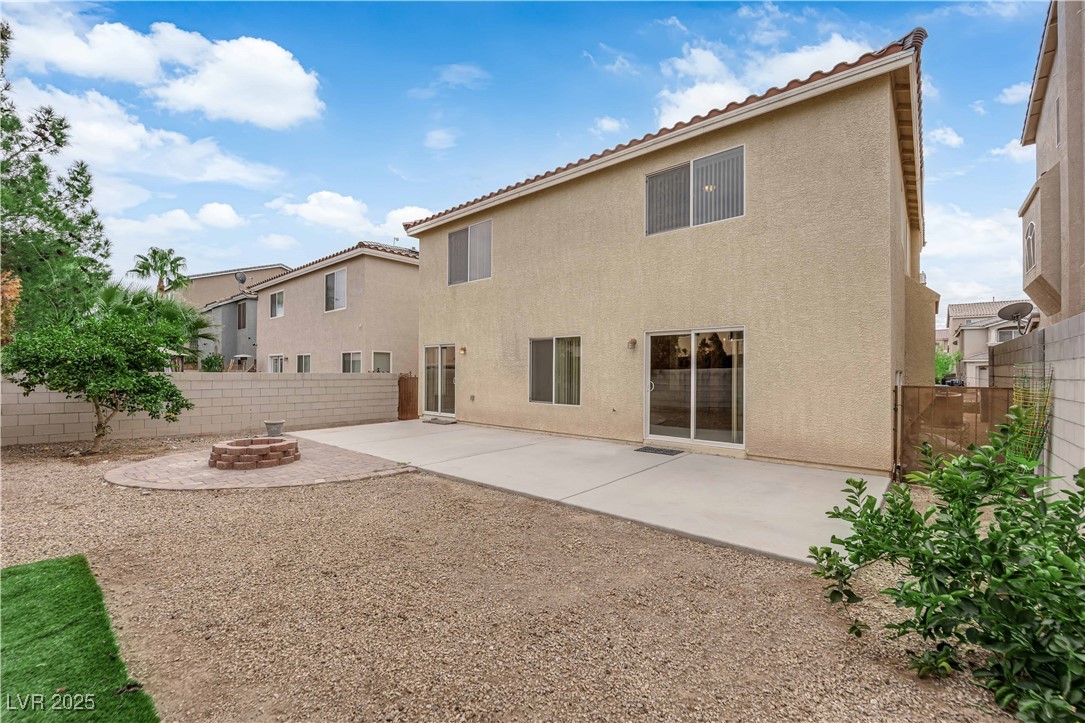 1142 Sax Fifth Avenue Henderson, NV 89052 - Photo 42 of 44 Low-maintenance yard featuring an extended concrete patio and brick fire-pit pad.