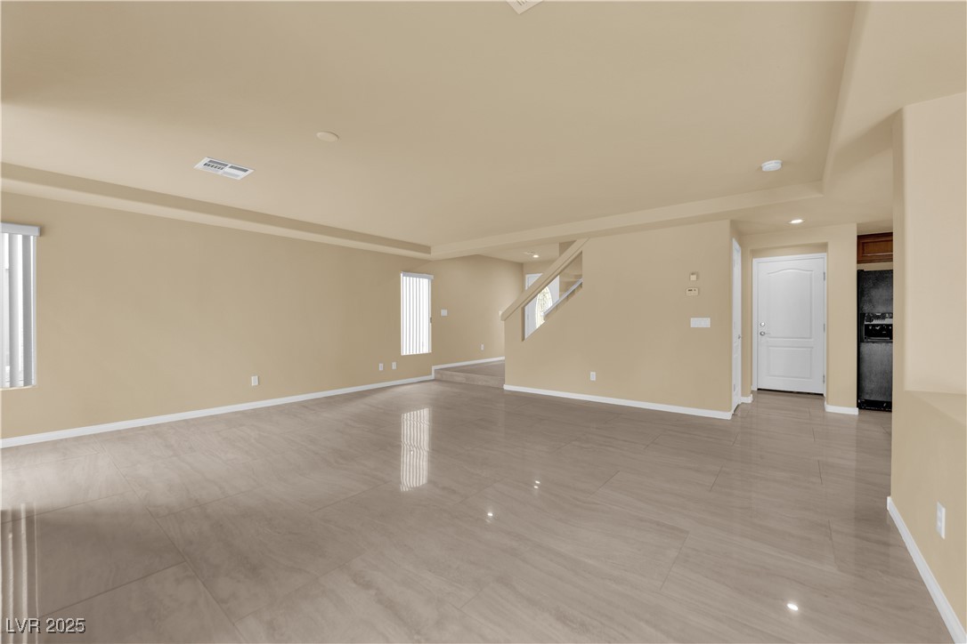 1142 Sax Fifth Avenue Henderson, NV 89052 - Photo 8 of 44 Bright and spacious living area featuring large windows and sliding doors to the backyard.