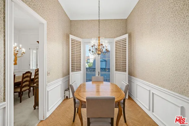 a view of a dining room with furniture and a chandelier
