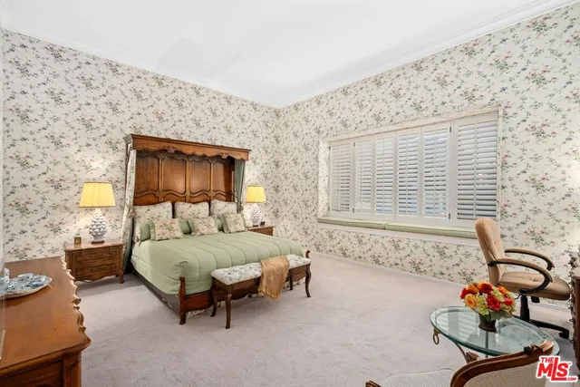 a bedroom with a bed and a dresser next to a window