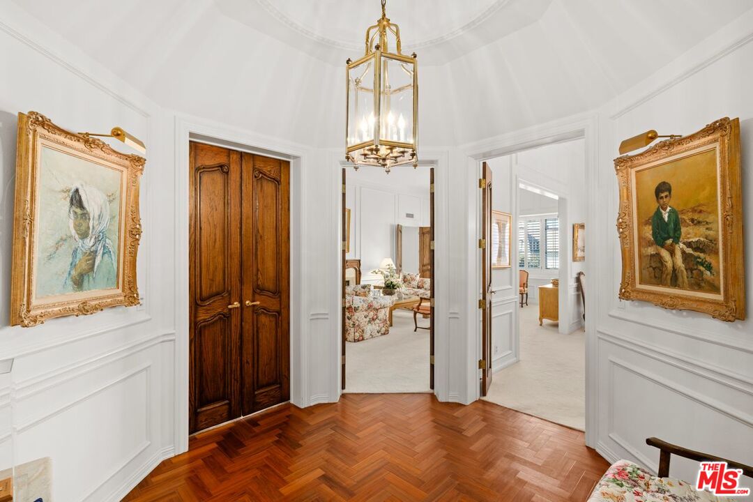 10114 Empyrean Way, Unit 302 Los Angeles, CA 90067 - Photo 2 of 37 a bedroom with a bed and a chandelier