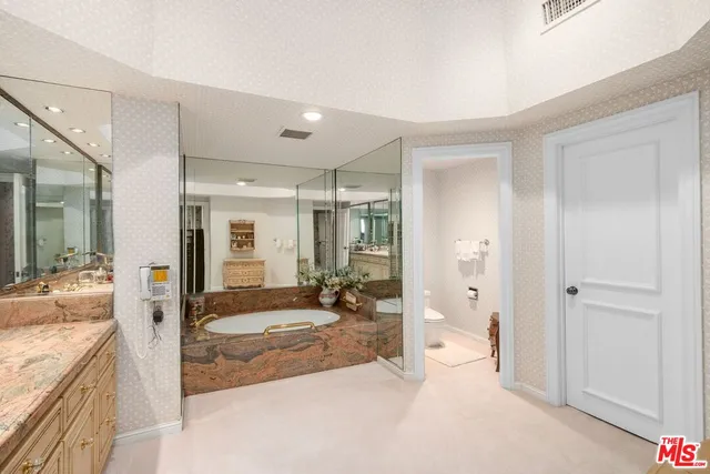 a spacious bathroom with a granite countertop tub shower and sink