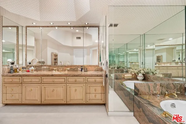 a large bathroom with a double vanity sink a mirror and a shower