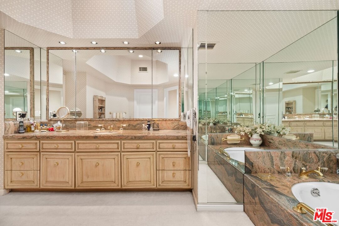 10114 Empyrean Way, Unit 302 Los Angeles, CA 90067 - Photo 25 of 37 a large bathroom with a double vanity sink a mirror and a shower