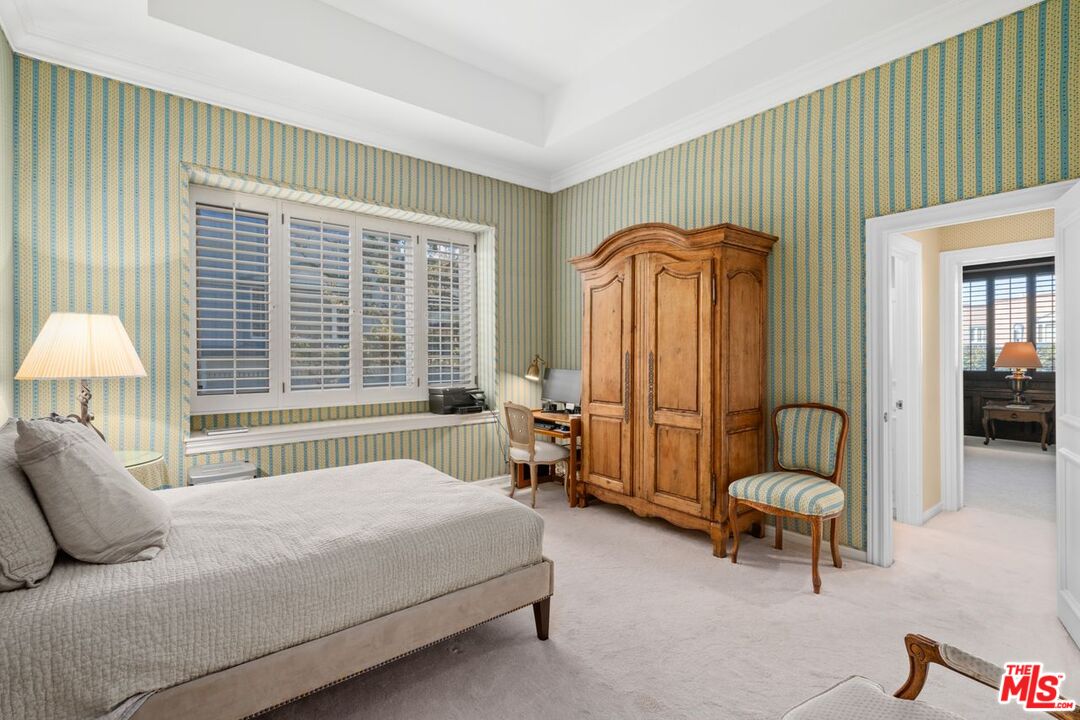 10114 Empyrean Way, Unit 302 Los Angeles, CA 90067 - Photo 26 of 37 a bedroom with a bed and a chandelier