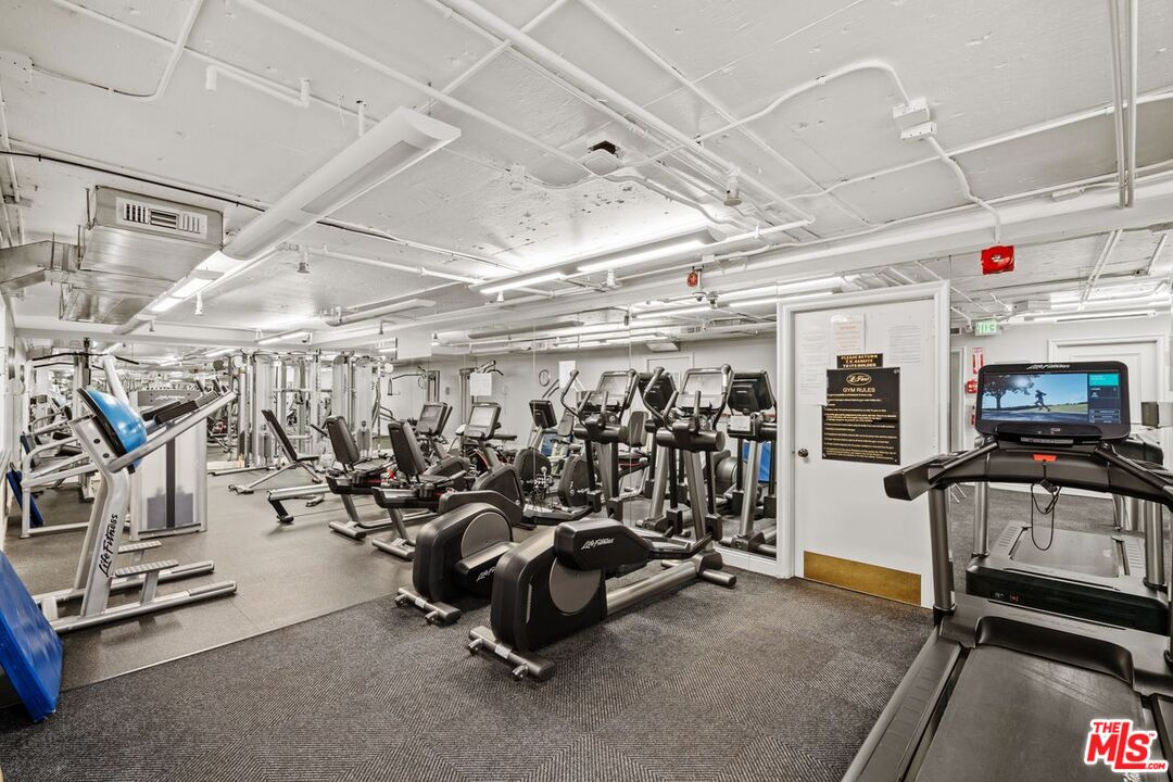 10114 Empyrean Way, Unit 302 Los Angeles, CA 90067 - Photo 34 of 37 a view of a room with gym equipment