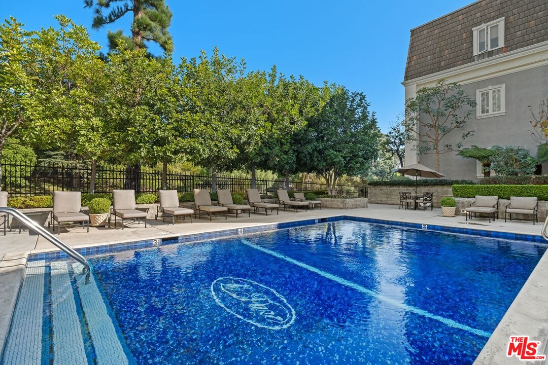 10114 Empyrean Way, Unit 302 Los Angeles, CA 90067 - Photo 36 of 37 a view of a swimming pool with a patio