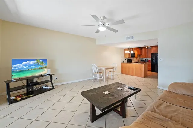 a view of a hallway to a livingroom with furniture