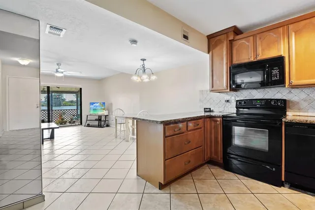 a kitchen with stainless steel appliances granite countertop a stove and a microwave
