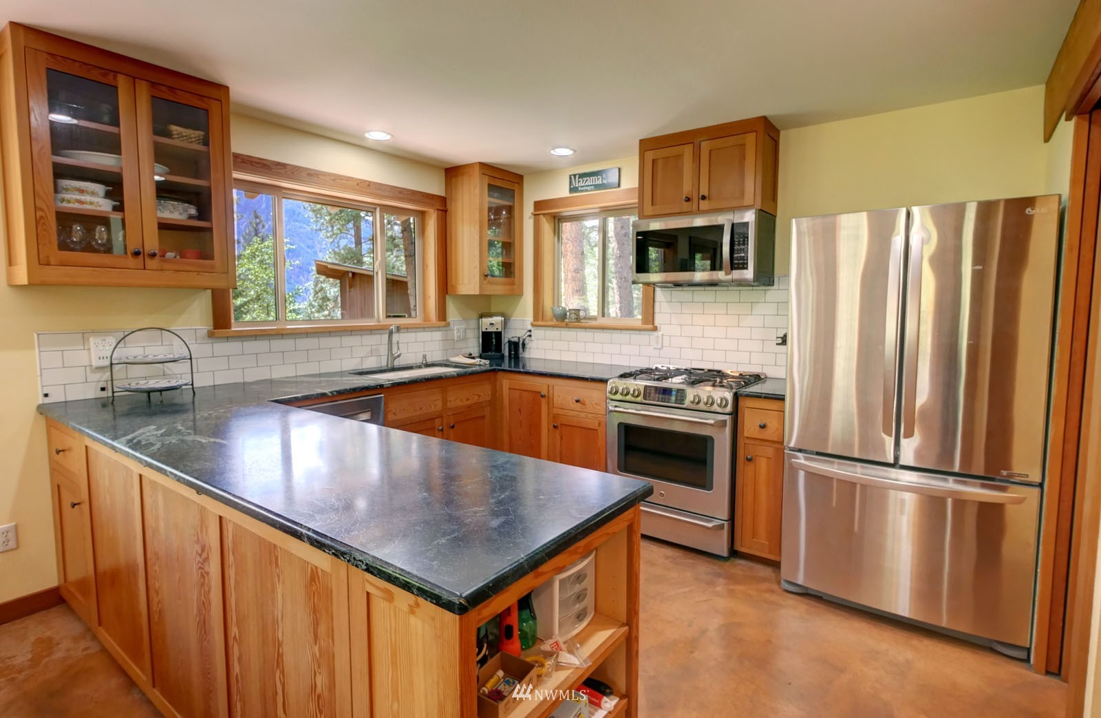 22 Trillium Road Winthrop, WA 98862 - Photo 11 of 40 a kitchen with stainless steel appliances granite countertop a refrigerator a stove and a sink with wooden floor
