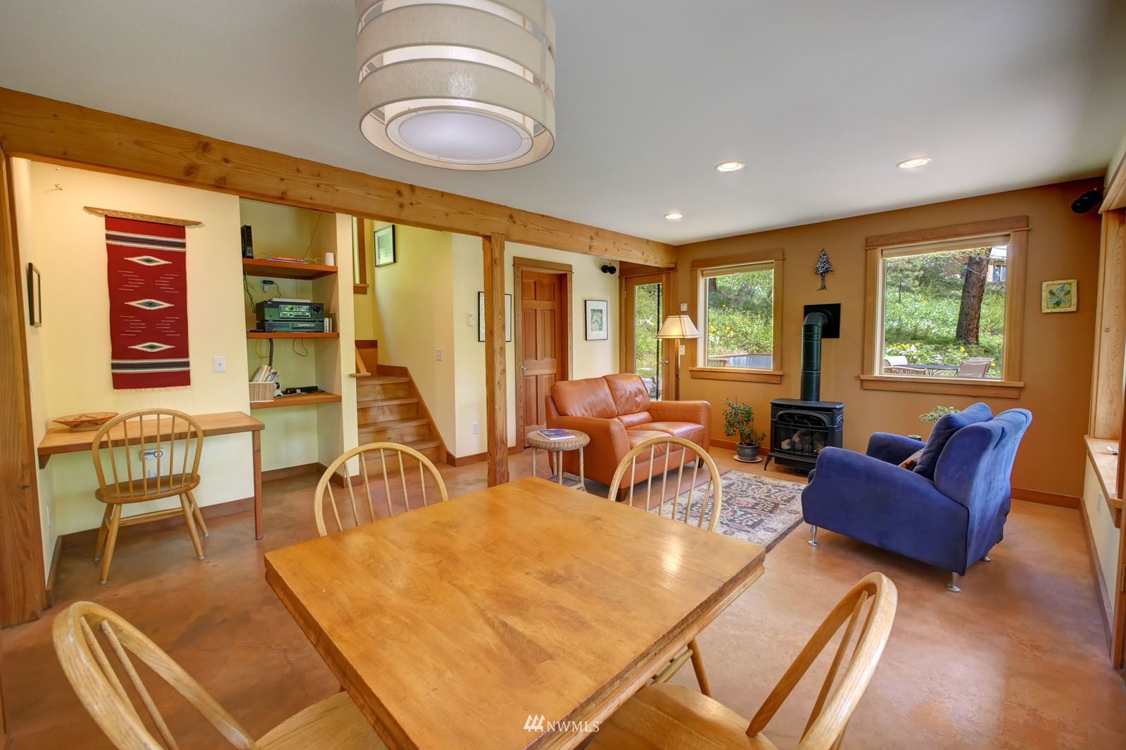 22 Trillium Road Winthrop, WA 98862 - Photo 17 of 40 a living room with furniture a fireplace and large windows