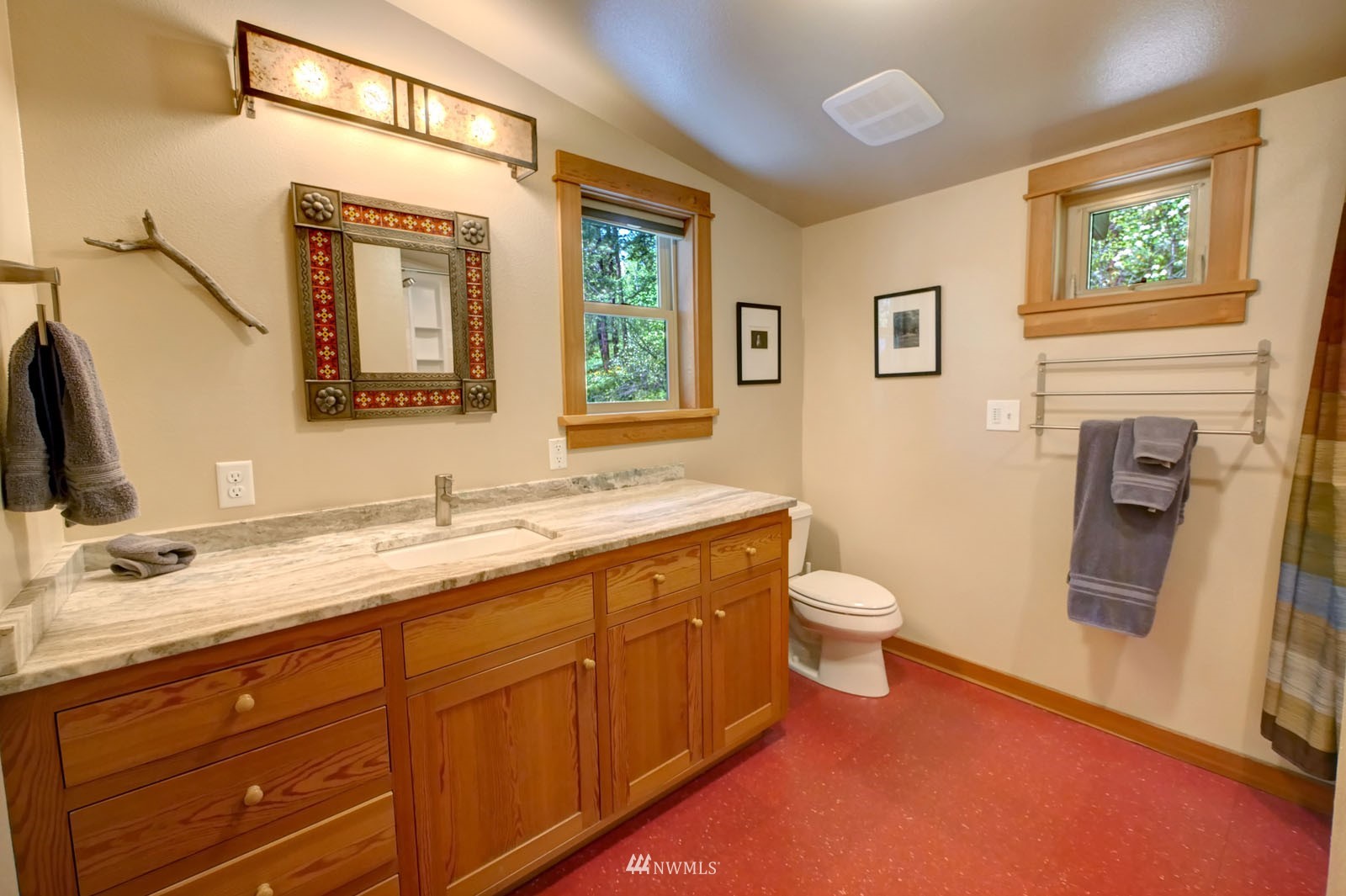22 Trillium Road Winthrop, WA 98862 - Photo 24 of 40 a bathroom with a toilet a sink a mirror and a window