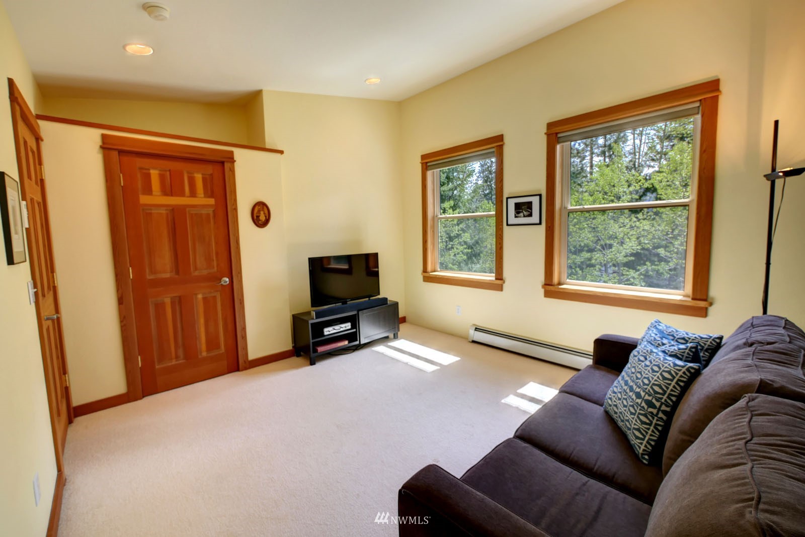 22 Trillium Road Winthrop, WA 98862 - Photo 27 of 40 a living room with furniture a window and a flat screen tv