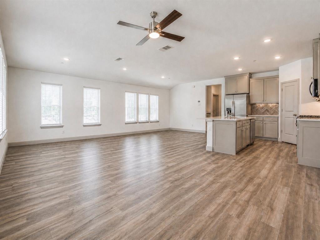 8913 Swallowtail Street Frisco, TX 75035 - Photo 7 of 38 a view of a kitchen with furniture and wooden floor