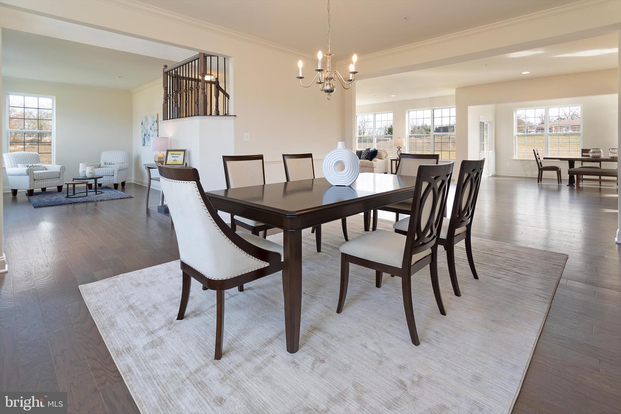 856 Imperial Road Arnold, MD 21012 - Photo 7 of 23 a view of a a dining room and livingroom with furniture a rug a fireplace and a chandelier