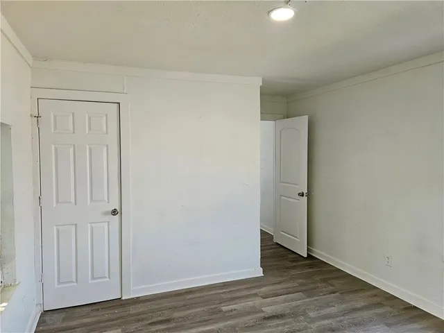 an empty room with wooden floor