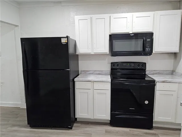 a kitchen with a refrigerator stove and microwave