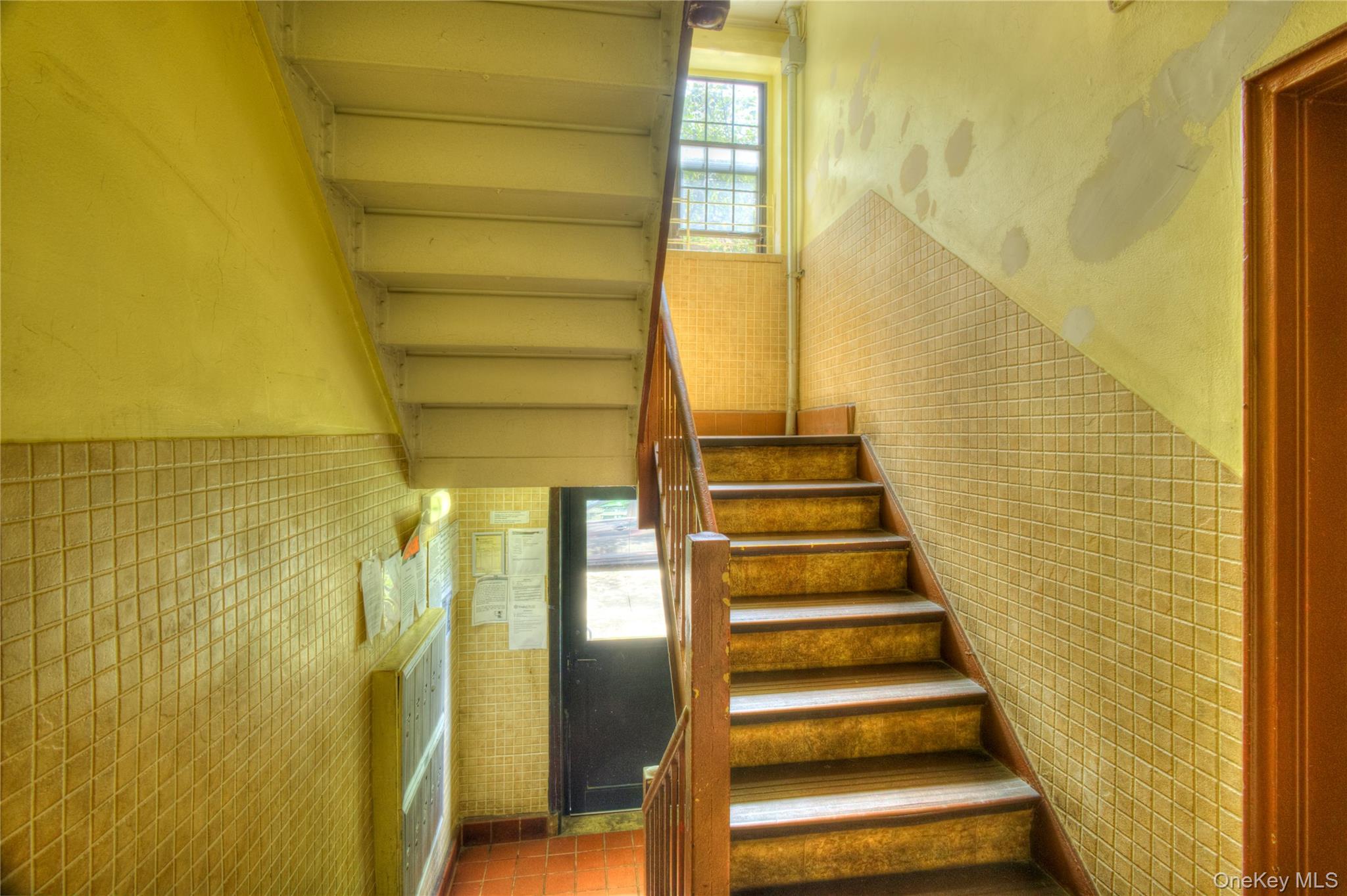14401 78th Road, Unit 2B Queens, NY 11367 - Photo 20 of 29 Stairway featuring plenty of natural light, tile walls, and tile patterned flooring