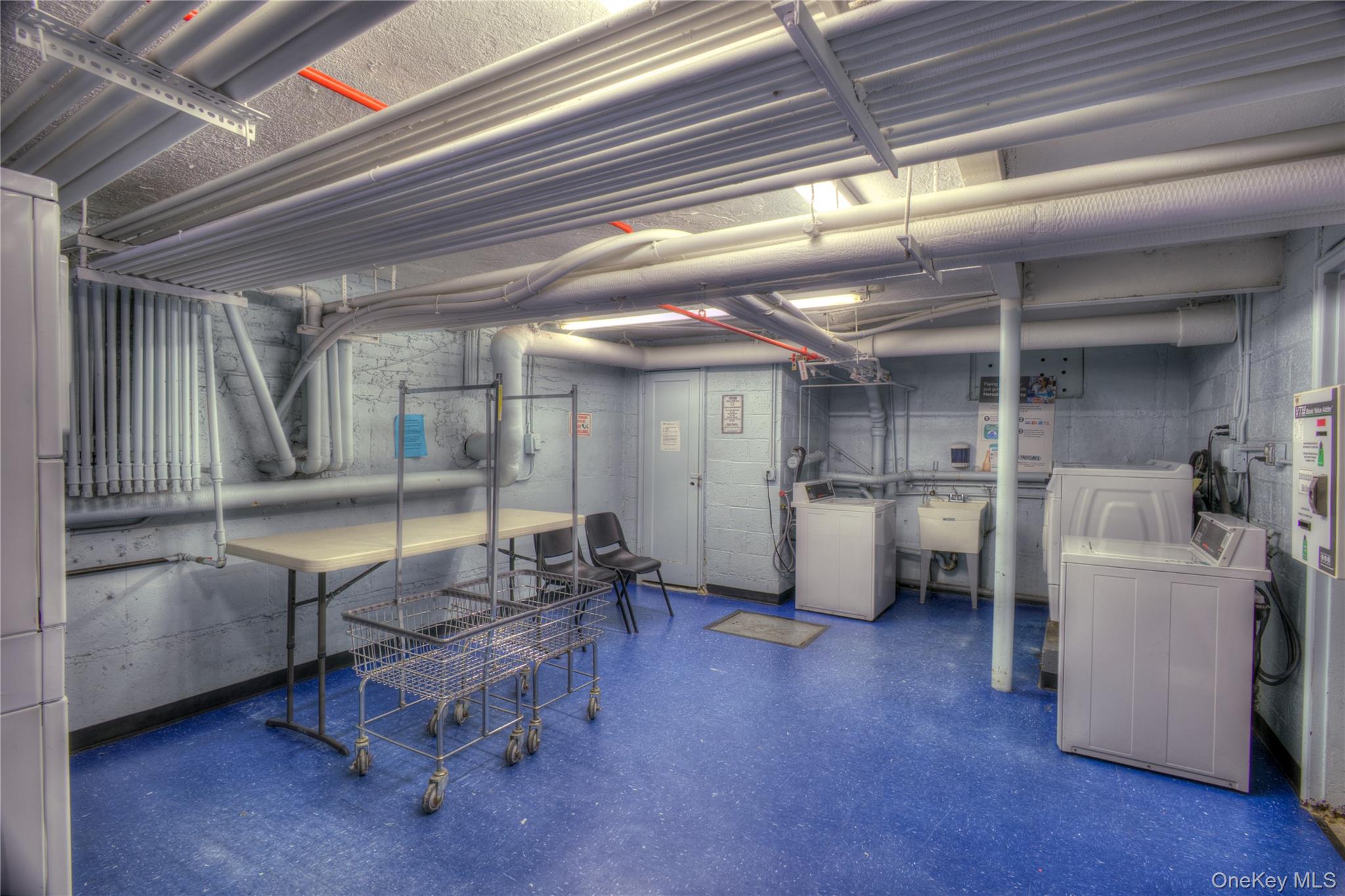 14401 78th Road, Unit 2B Queens, NY 11367 - Photo 23 of 29 Unfinished below grade area featuring washer and dryer and water heater