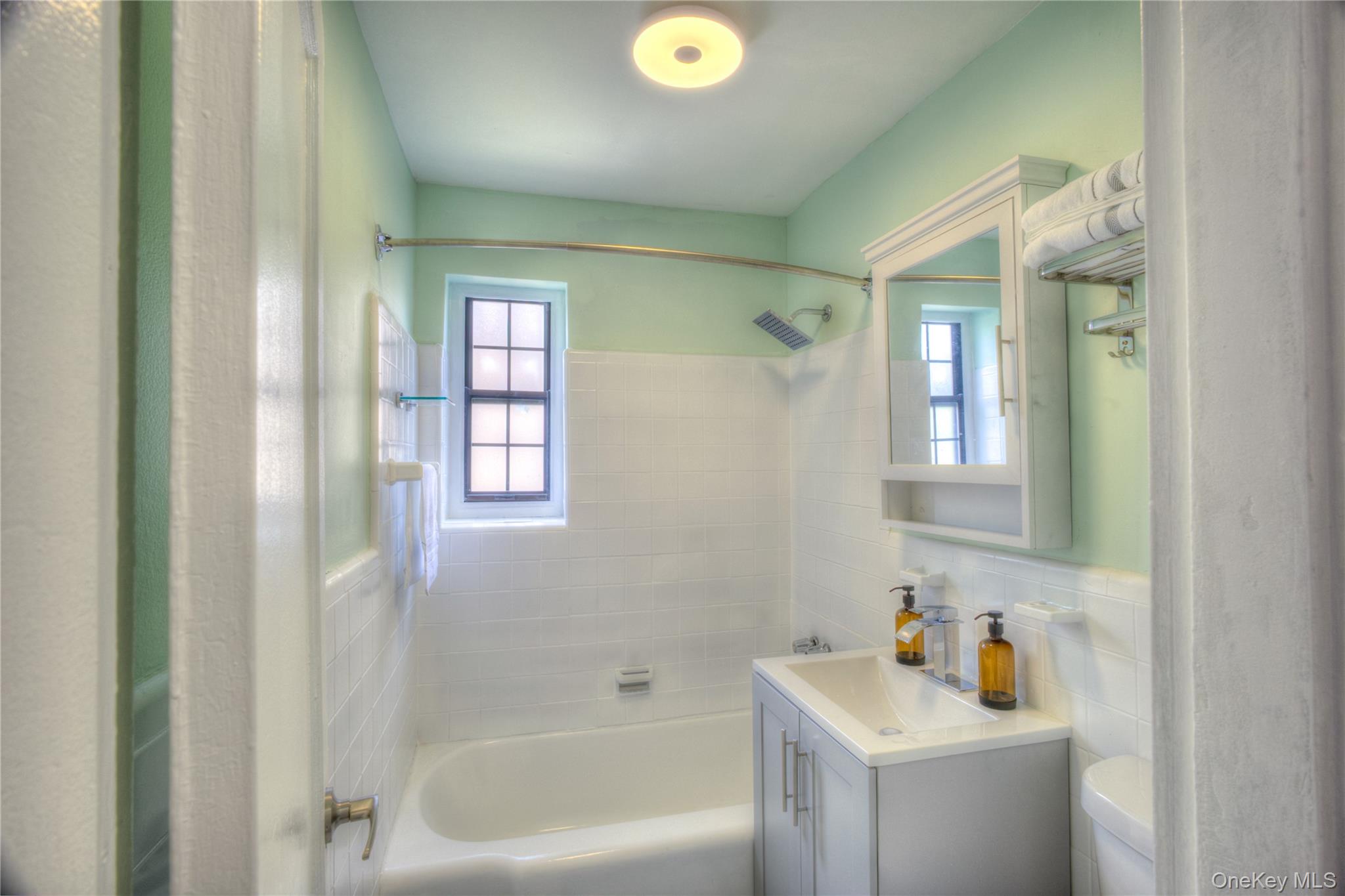 14401 78th Road, Unit 2B Queens, NY 11367 - Photo 28 of 29 Bathroom featuring shower / tub combination, vanity, tile walls, and tasteful backsplash