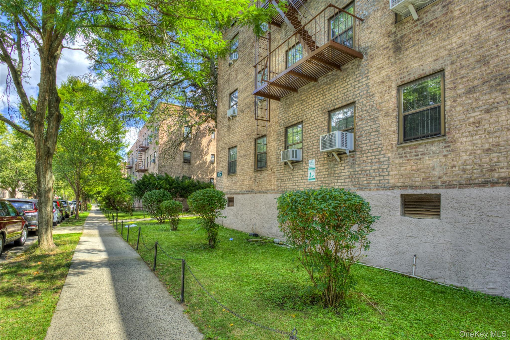 14401 78th Road, Unit 2B Queens, NY 11367 - Photo 29 of 29 View of home's exterior featuring a lawn and brick siding