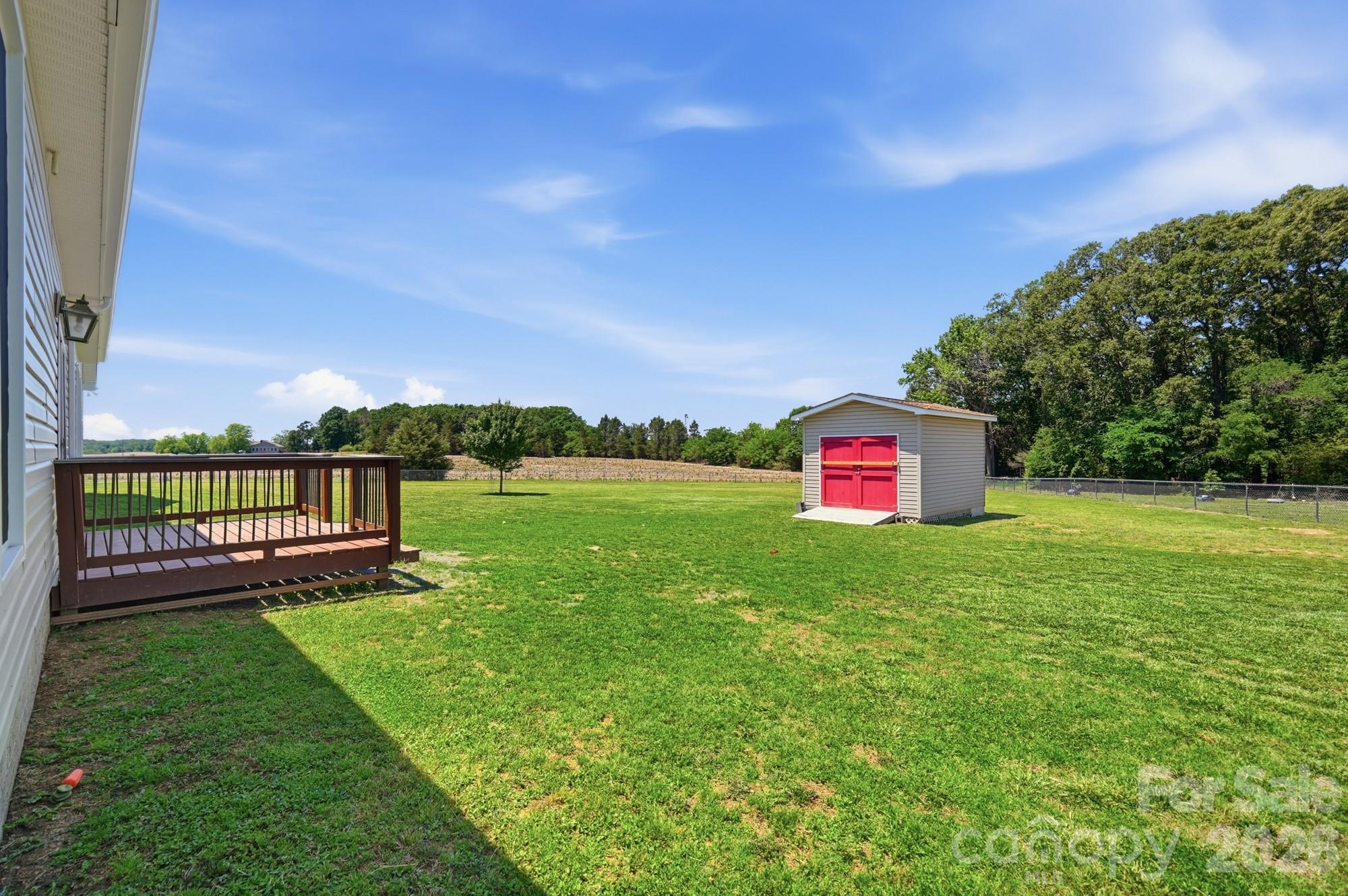 4415 Old Monroe Marshville Road Wingate, NC 28174 - Photo 24 of 28 a green field with trees in the background