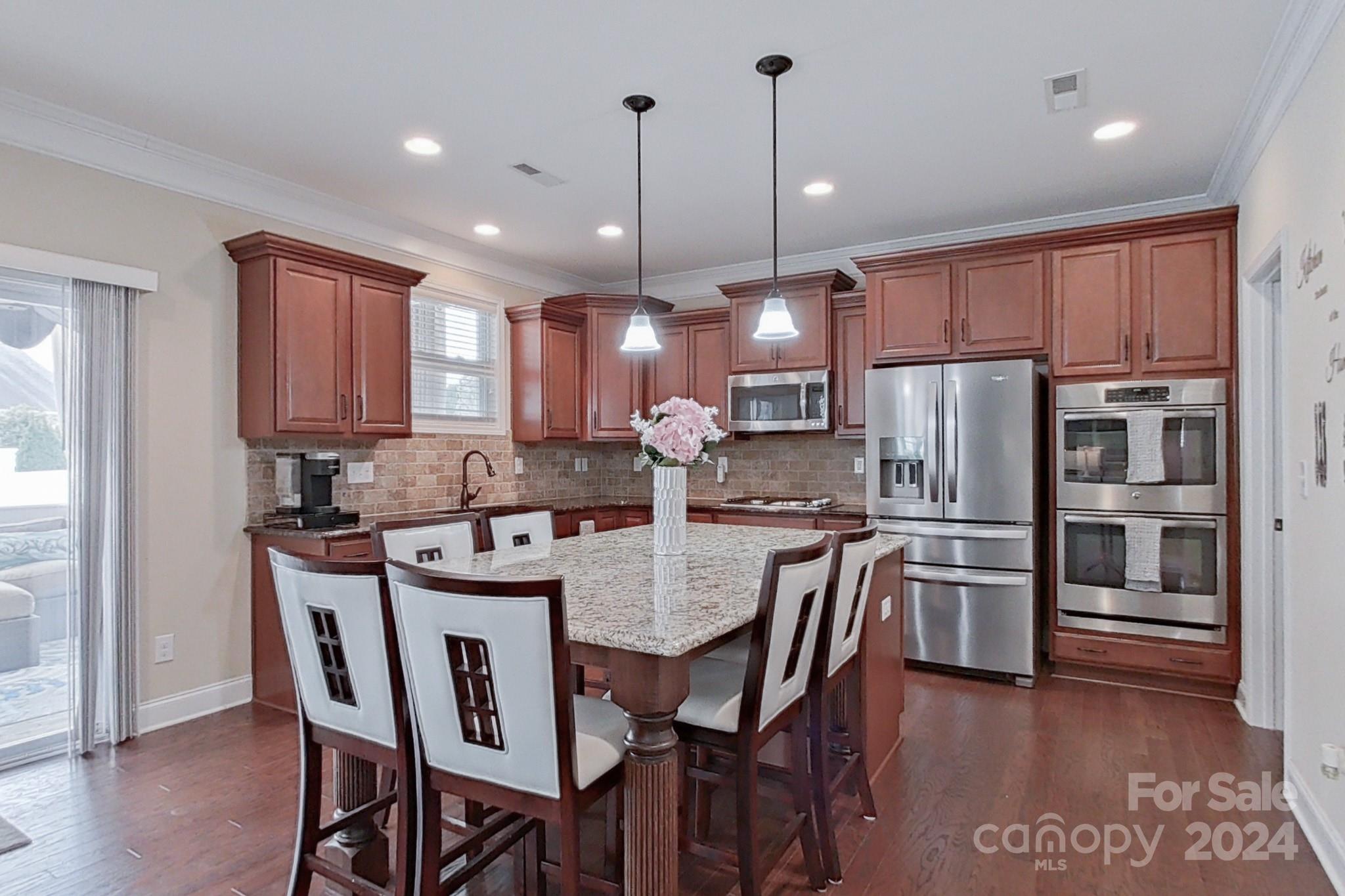 79007 Ridgehaven Road Lancaster, SC 29720 - Photo 14 of 48 a kitchen with stainless steel appliances granite countertop a stove a refrigerator a kitchen island a table and chairs