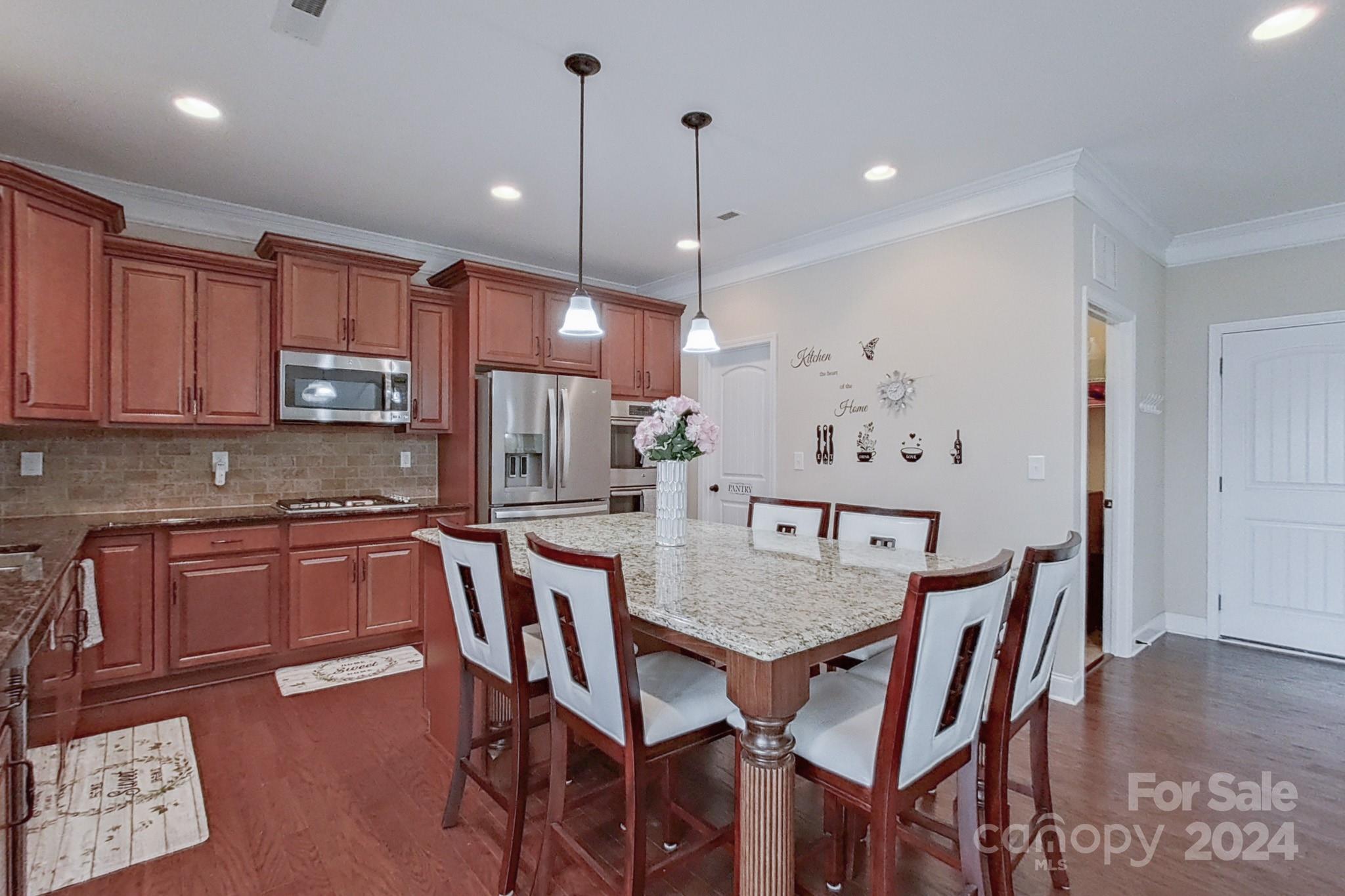 79007 Ridgehaven Road Lancaster, SC 29720 - Photo 16 of 48 a kitchen with stainless steel appliances granite countertop a kitchen island a table and chairs in it