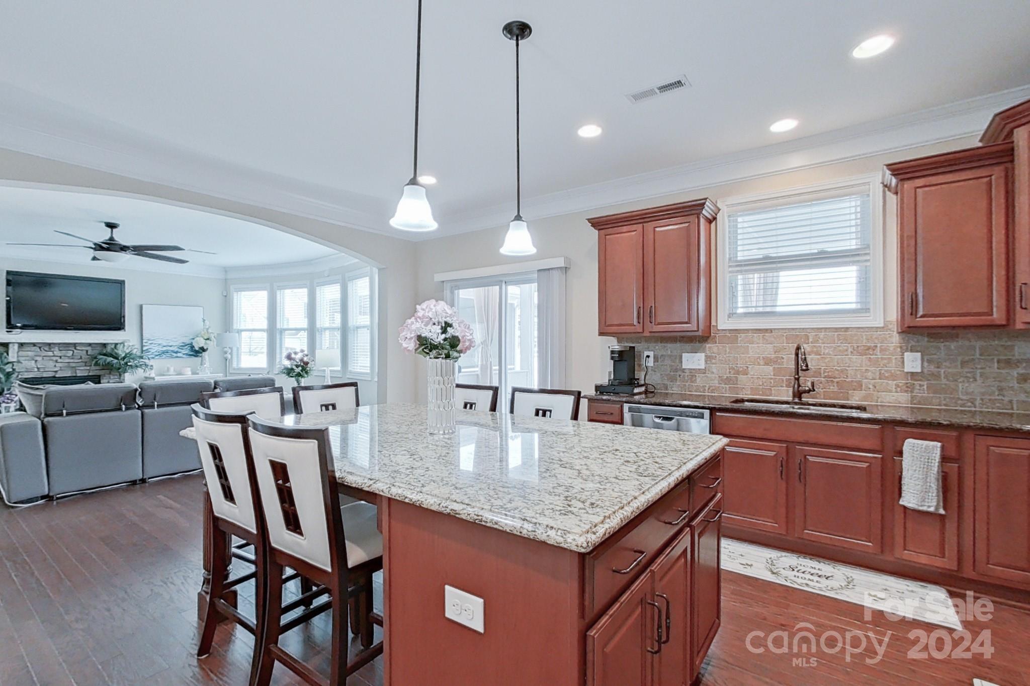 79007 Ridgehaven Road Lancaster, SC 29720 - Photo 17 of 48 a kitchen with kitchen island granite countertop a table chairs sink and microwave