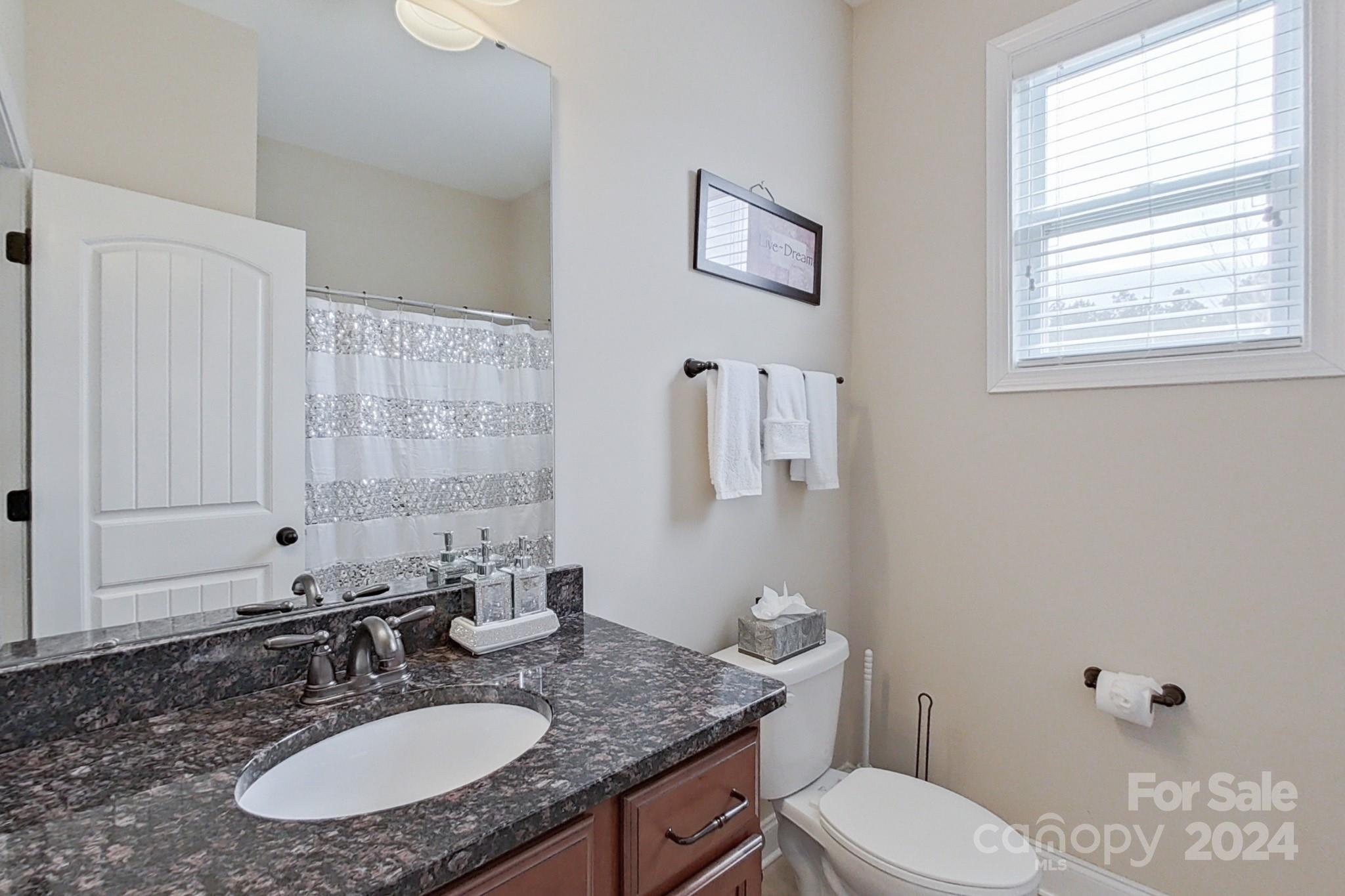 79007 Ridgehaven Road Lancaster, SC 29720 - Photo 21 of 48 a bathroom with a granite countertop toilet sink and mirror