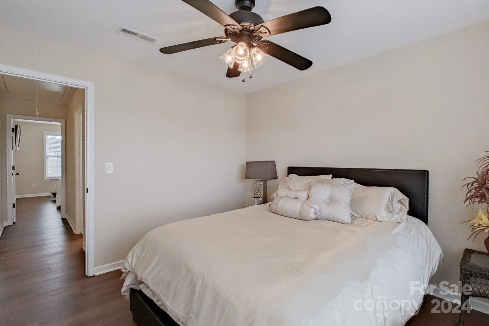 79007 Ridgehaven Road Lancaster, SC 29720 - Photo 31 of 48 a bedroom with a bed and a chandelier