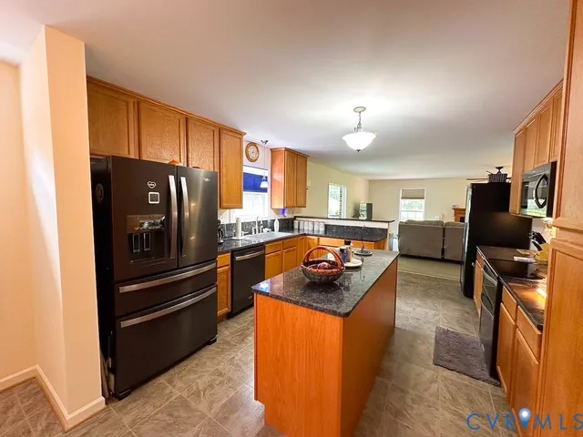 a kitchen with sink a counter top space and living room