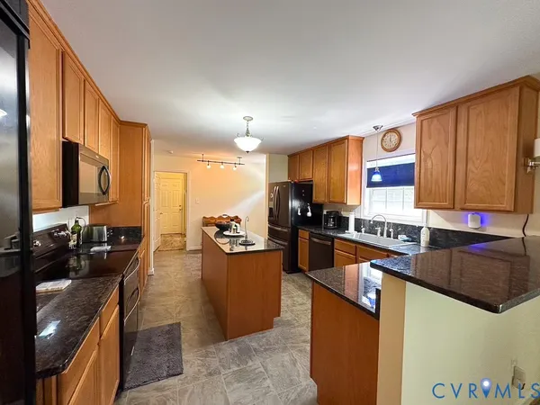 a kitchen with sink a counter top space and living room