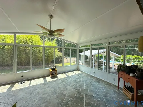 a view of a porch with chairs and backyard