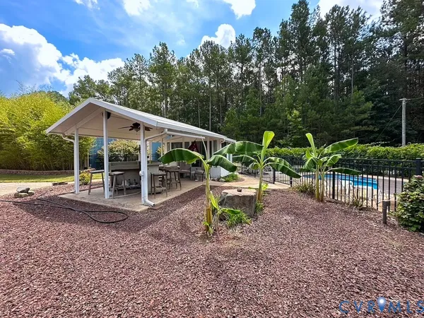 a view of a house with backyard porch and sitting area