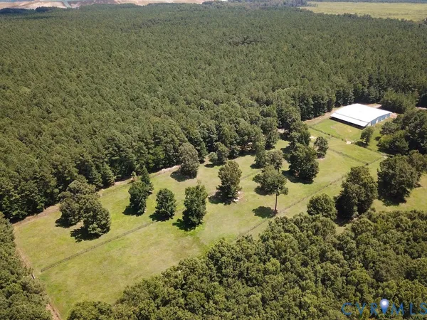 a view of a lake in middle of the green field