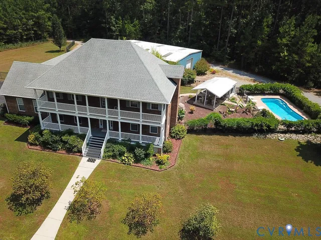 a view of a house with swimming pool and sitting space