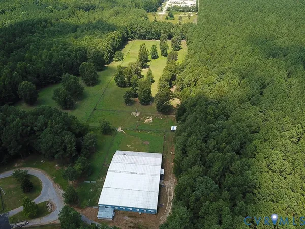 an aerial view of a house with pool