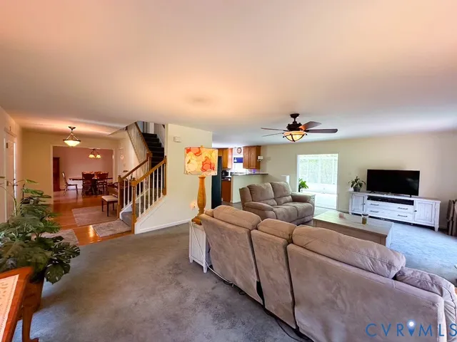 a dining room with furniture a rug and wooden floor