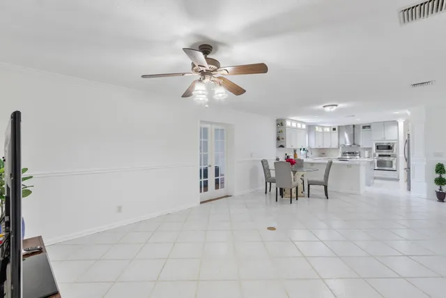 a view of a dining room with furniture and chandelier
