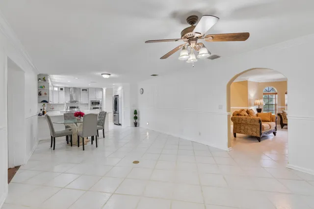 a kitchen with a dining table chairs and white cabinets
