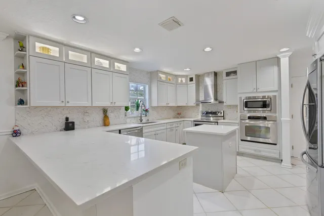 a kitchen with granite countertop white cabinets and white appliances