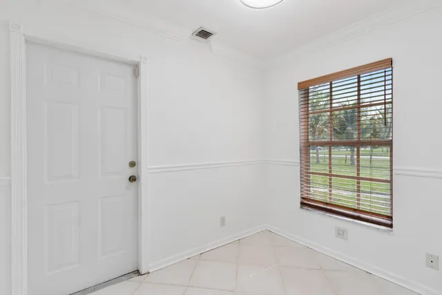 a bathroom with a granite countertop sink vanity mirror and toilet